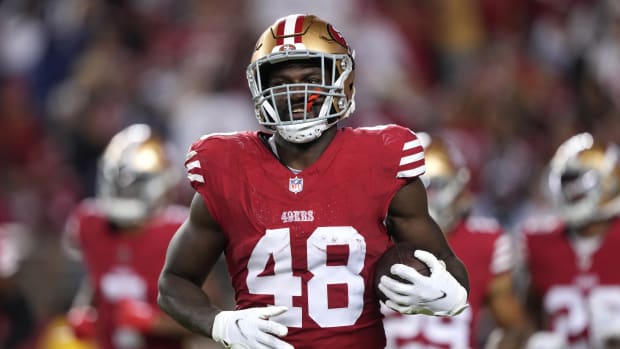 Oct 8, 2023; Santa Clara, California, USA; San Francisco 49ers linebacker Oren Burks (48) jogs off of the field with the game ball after an interception against the Dallas Cowboys during the fourth quarter at Levi's Stadium. Mandatory Credit: Darren Yamashita-USA TODAY Sports